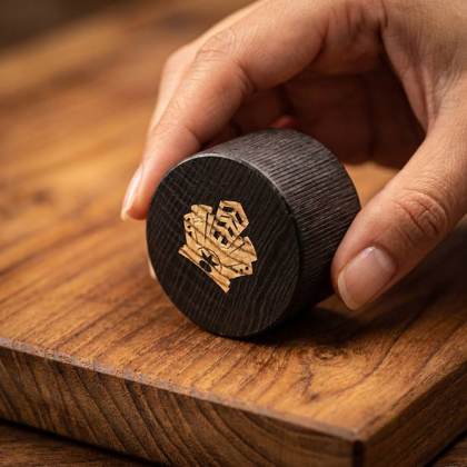 Dark ash-wood cap with gold-inlaid crest